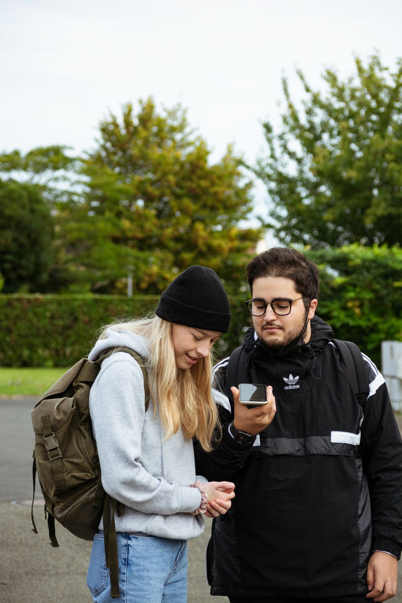 a man and a woman looking at a cell phone